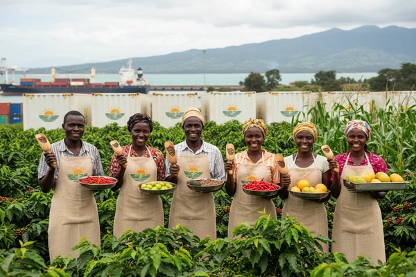 Smallholder farmer cooperative members smiling in their thriving crop field